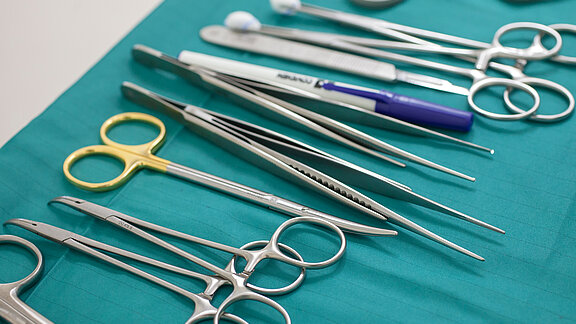Operationsinstrumente auf einem grünen OP-Tuch